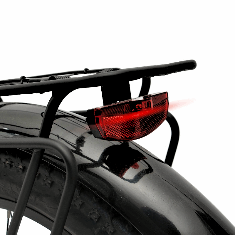 Rear view of the FAT-HD eBike’s fender and rack, featuring a bright red tail light for added visibility.