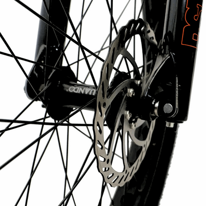 Close-up of the FAT-HS eBike's front brake system, focusing on the disc brake rotor and spokes for improved stopping power.