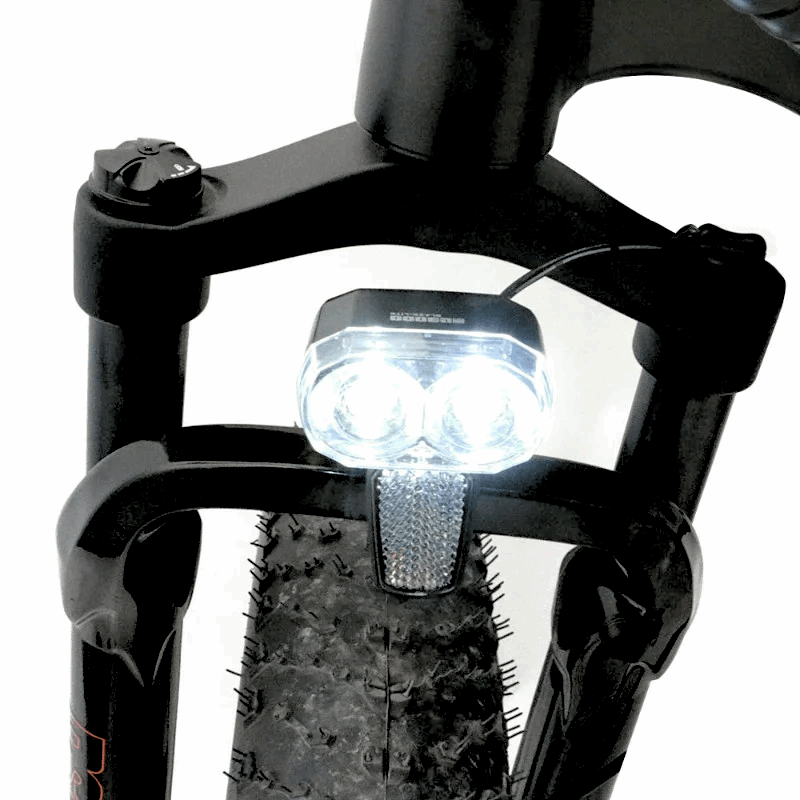 Front view of the FAT-HS eBikeâ€™s headlight, mounted on the suspension fork, providing illumination for riding in low light conditions.