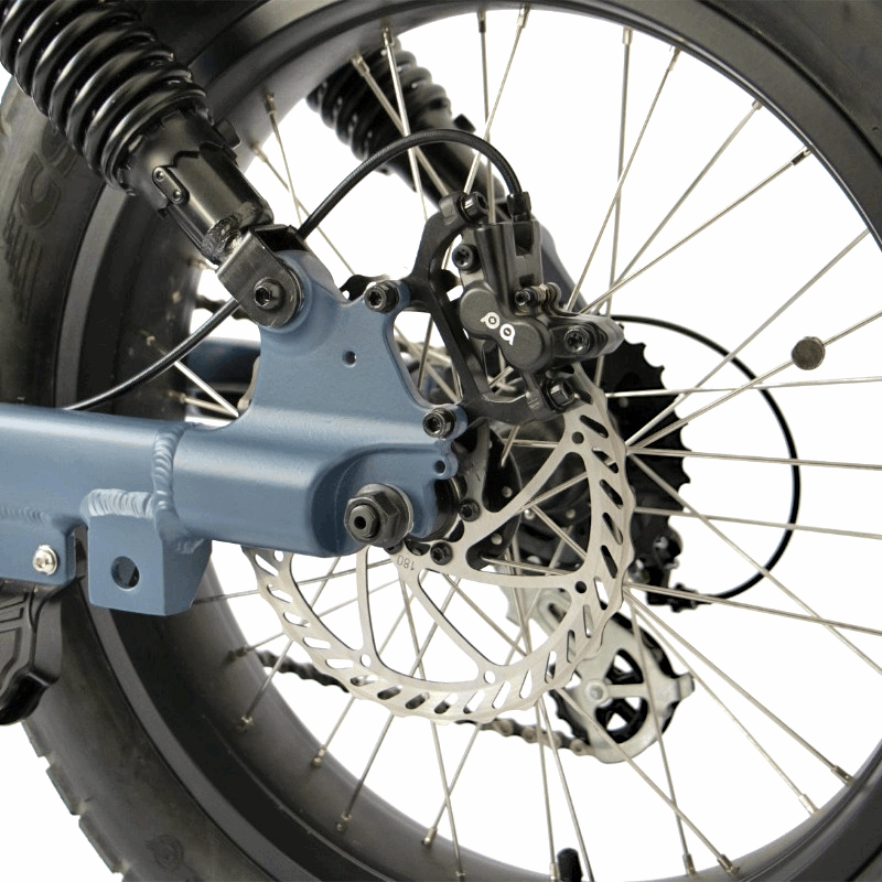 Close-up of an e-bike's rear wheel suspension system, showcasing the disc brakes and sturdy build for enhanced stopping power and durability.