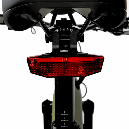 Close-up of the rear red reflector mounted under the saddle of an e-bike, providing enhanced visibility and safety for riding at night or in low-light conditions.