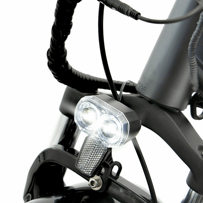 Close-up of the FAT-HD eBikeâ€™s front headlight, attached to the suspension fork for bright illumination during night rides.