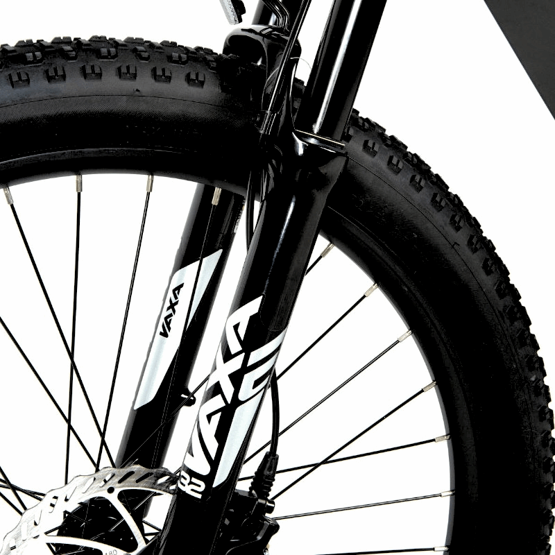 Close-up of the Zoom Vaxa 100mm suspension fork on an e-bike, designed to absorb shocks and bumps, improving comfort and handling on rough terrain.