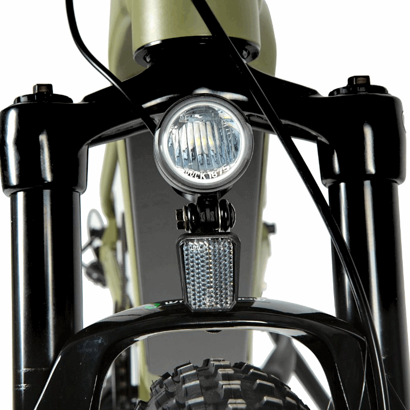 Close-up of an LED headlight mounted on the front suspension of an e-bike, powered by the main battery pack and controlled through the display, ensuring visibility and safety during night rides.