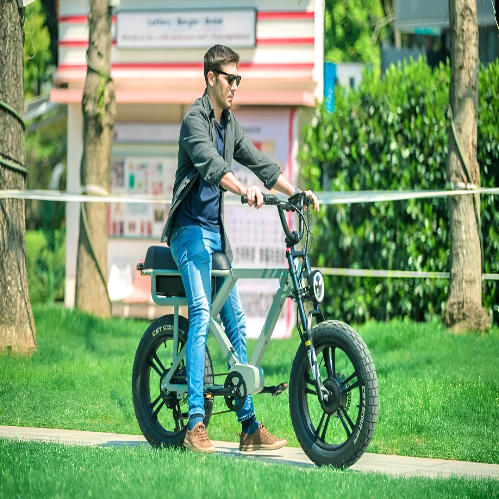 Two riders, a man and a woman, casually riding their EUNORAU e-bikes in front of a glass building, enjoying a relaxed ride on a sunny day.