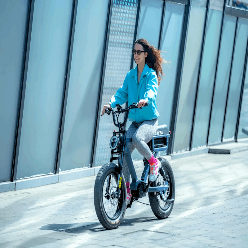 A woman riding the EUNORAU e-bike on a green lawn, emphasizing the bike's comfort and ease of use in recreational settings.