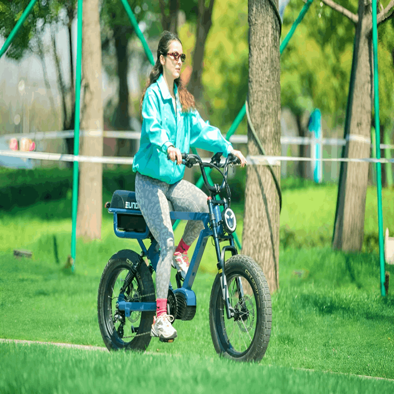 A woman riding the EUNORAU e-bike on a city street, enjoying a leisurely ride with the wind in her hair, highlighting the bike's urban appeal.