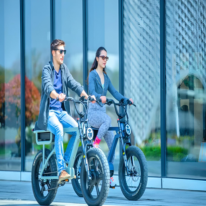 A man and woman riding their EUNORAU e-bikes side by side on a street, enjoying a relaxing ride on a sunny day in front of modern glass architecture.