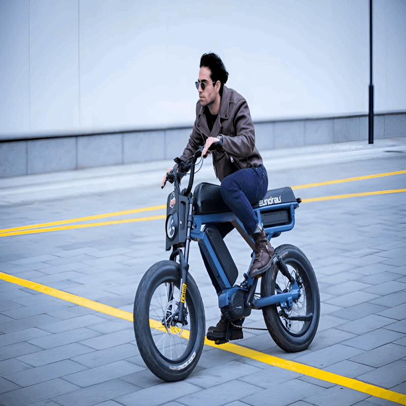 A man wearing a leather jacket riding the EUNORAU e-bike on a paved road, focusing on speed and style.