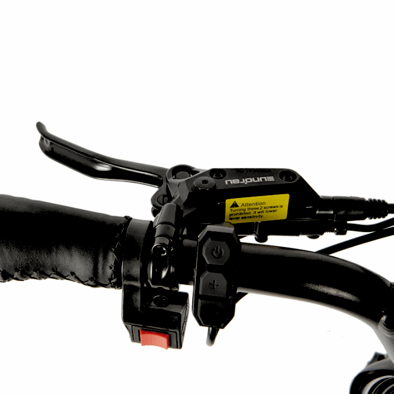 Close-up of an e-bike handlebar featuring a brake lever, power buttons, and a caution label for safe operation.