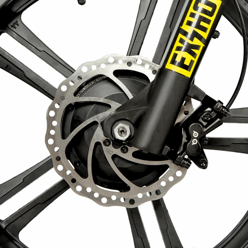 Close-up of an e-bike's front wheel, showing the disc brake system with a 180mm rotor and caliper for reliable stopping power.