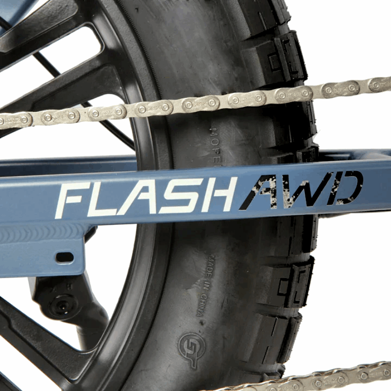 Close-up of the FLASH AWD bike's chain and logo on the rear chainstay, highlighting its all-wheel-drive capability.