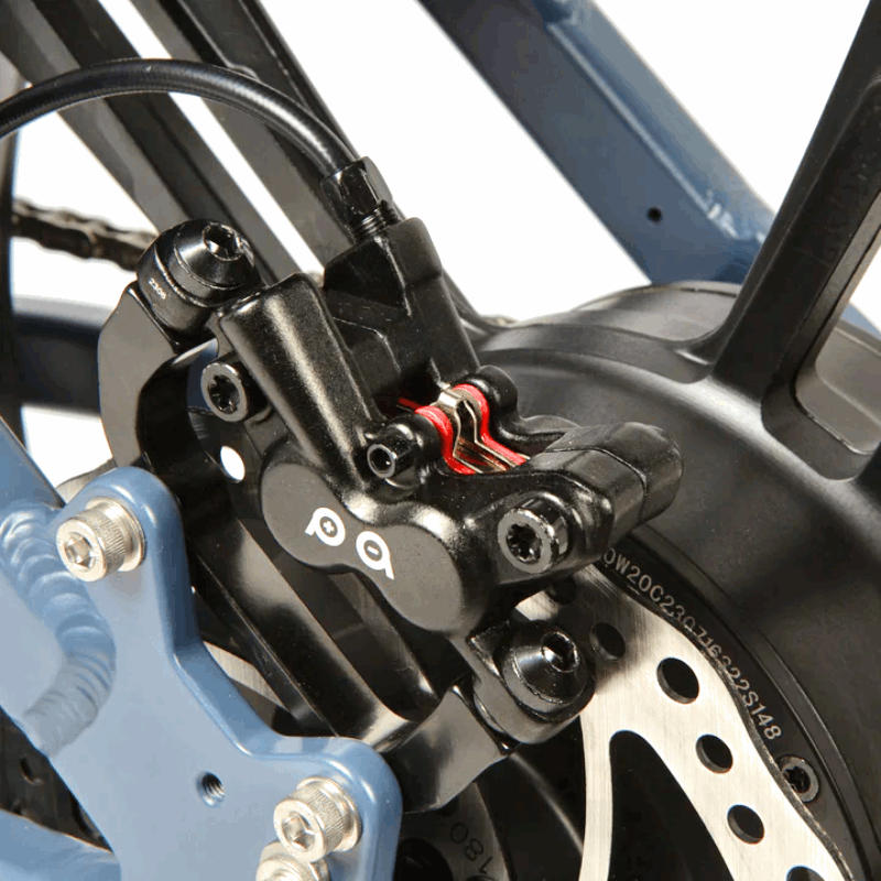 Detailed view of the hydraulic disc brake caliper on the rear wheel of the FLASH AWD e-bike.