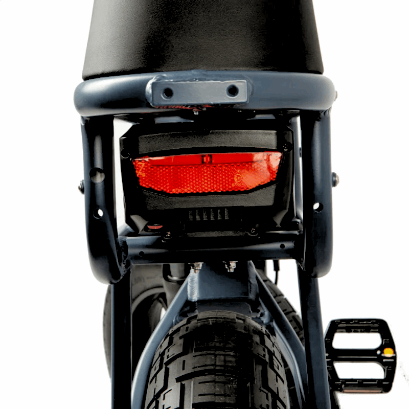 Rear view of an e-bike showing the taillight and back of the seat, designed for improved visibility and safety during rides.