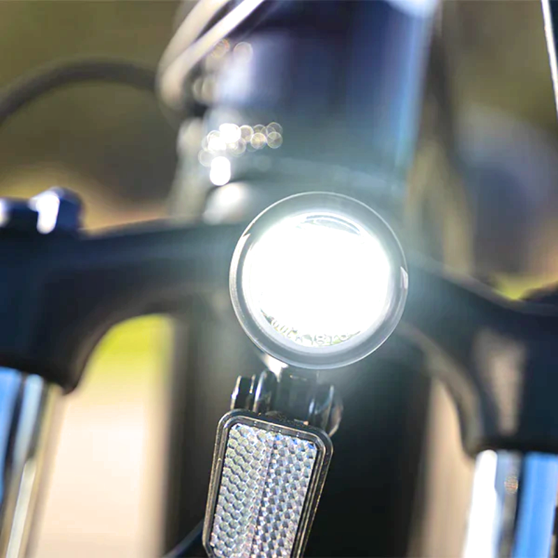 Front LED headlight of the META275 eBike for improved visibility during night rides.