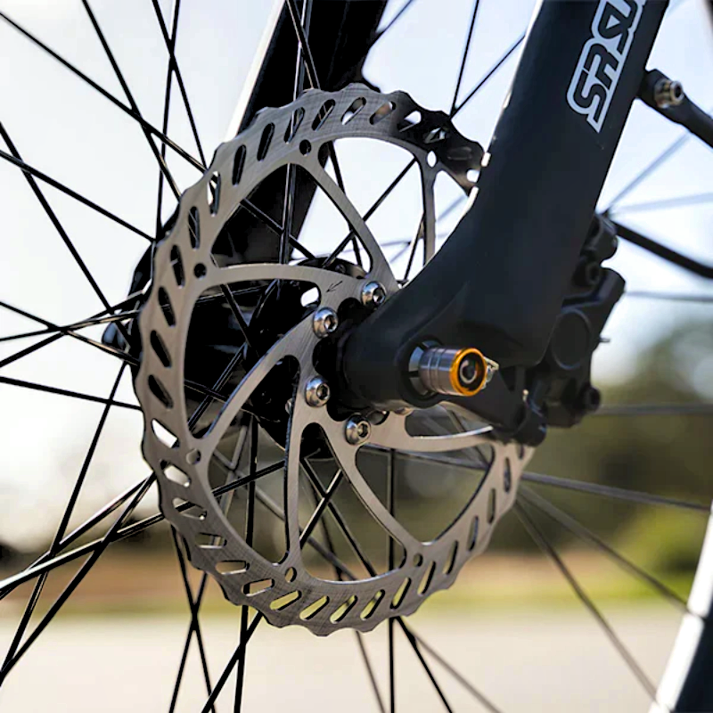 Close-up of the META275 eBike front wheel and disc brake.