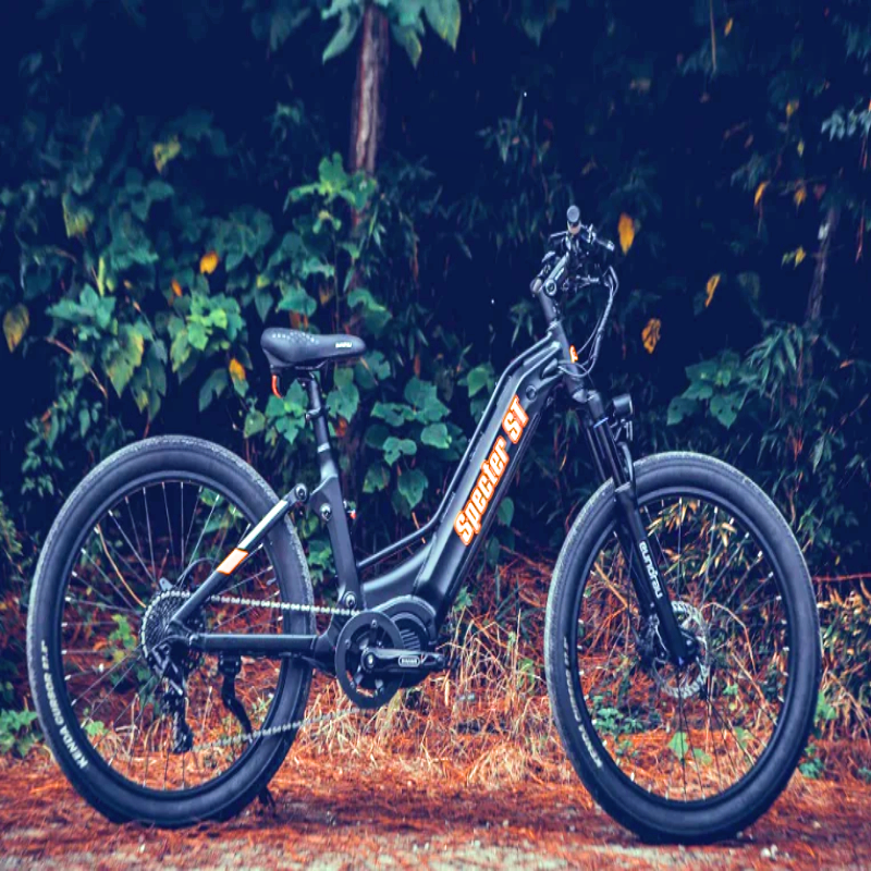 Side profile of the SPECTER-ST Full Suspension Mid-Drive Elite Electric Mountain Bike in a forested area, showcasing its rugged design and step-through frame.