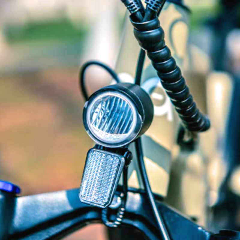 Close-up of the LED headlight on the SPECTER-S eBike mounted on the front fork.