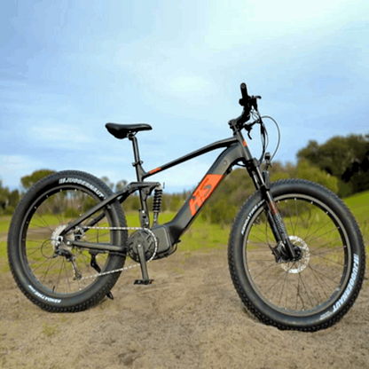 Full side view of the FAT-HS eBike standing on a dirt path, showcasing the fat tires, suspension system, and overall design, ready for off-road adventures.