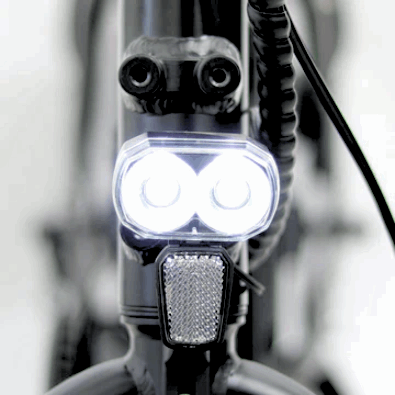 Front LED headlight of the FAT-MN Folding eBike, designed for bright illumination during night rides or low-light conditions.