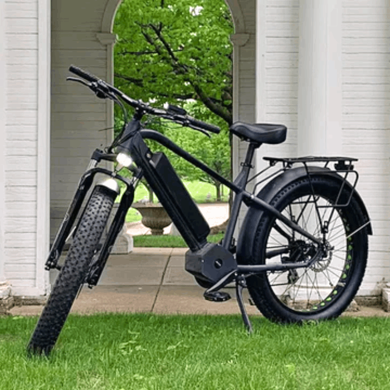 Side view of the FAT-HD eBike standing outdoors, showcasing its large fat tires, integrated battery, and front suspension system.