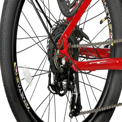 Close-up view of the rear wheel and drivetrain of the EUNORAU eBike, showing the rear derailleur, chain, and the large META24 tire with reflective accents on the spokes.