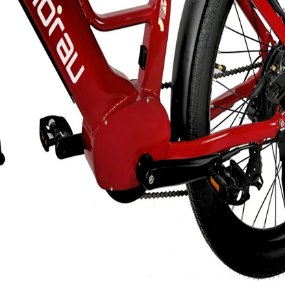 Close-up view of the red EUNORAU eBike's bottom bracket area, highlighting the crankset, pedals, and rear wheel with fat tires.