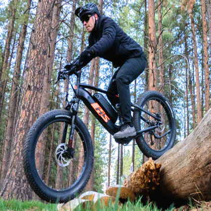 This shows a rider on an electric mountain bike, suited for off-road trails. The bike features a robust design with a suspension fork, ideal for absorbing shocks on rough terrain. The fat tires provide excellent traction and stability, while the rider's gear indicates readiness for outdoor adventure and challenging trails.